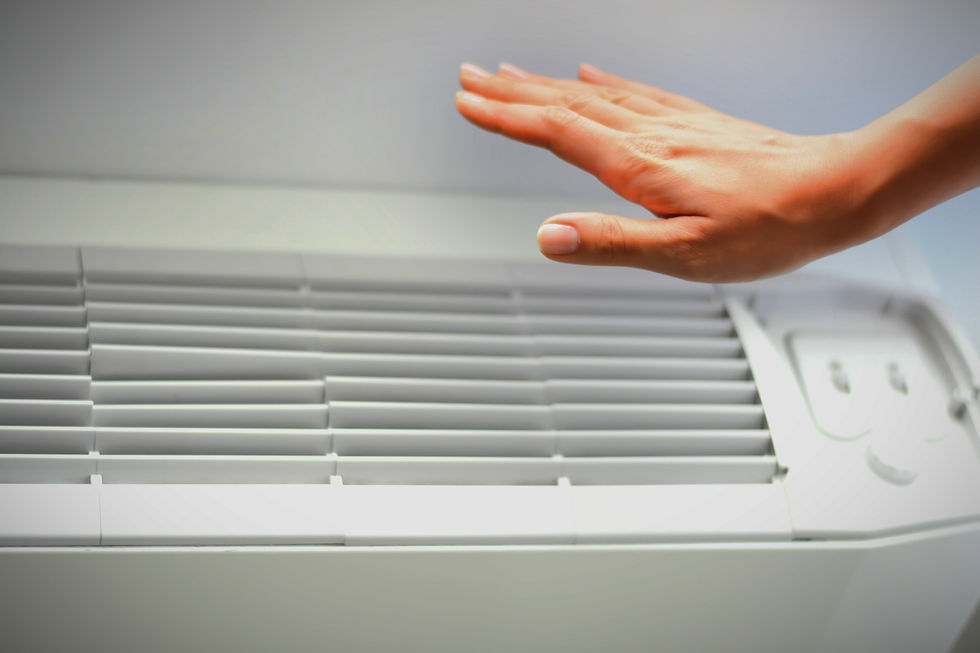 hand reaching out to check for airflow on an indoor HVAC unit from Comfort technology Hampton Va