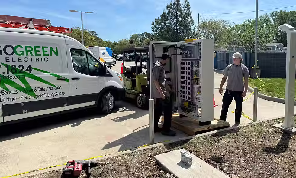 Go Green Electric Commercial elecrical service tech working on installing an industrial electrical panel in the street
