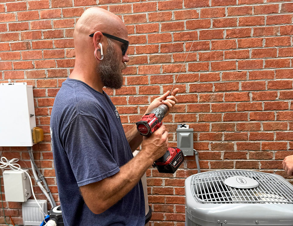 Comfort Technology Heating and Air Conditioning Tech performing an HVAC tune-up in Carrollton VA
