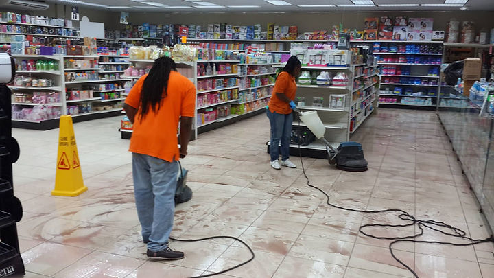 Two janitors cleaning a store floor