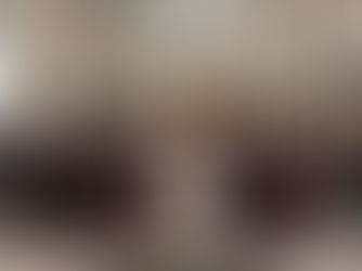 A large group of clergy and attendees sit in an ornate, frescoed room. Central figure in white, surrounded by cardinals in black and red.