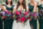 bride and bridesmaids with jewel toned florals