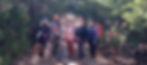 Five women stand in a line on a dirt trail.