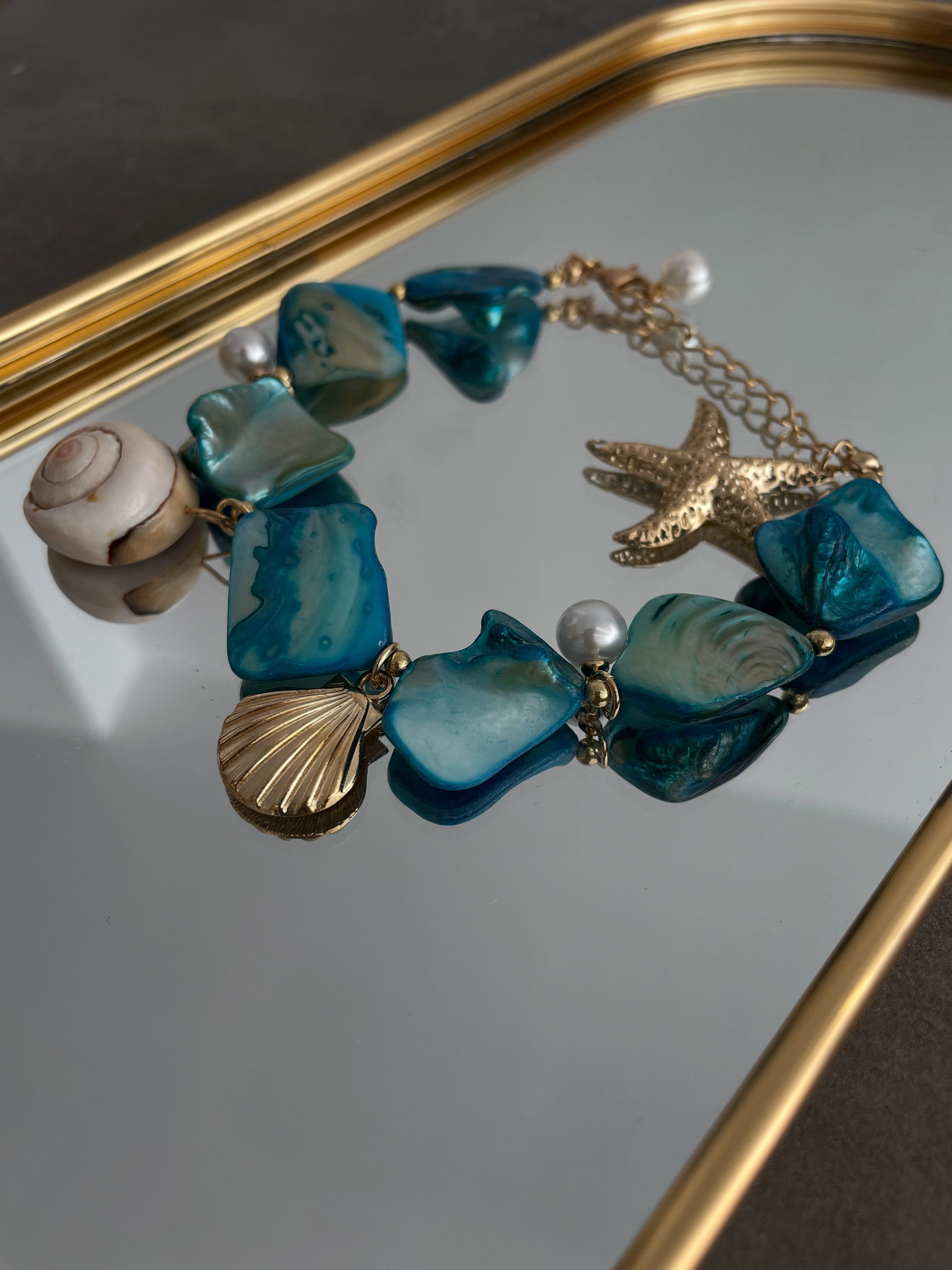 bracelet with blue pebble beads and 5 charms