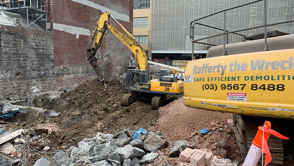 Demolition of multi-level concrete buildings at HEIX, 595–597 Little Collins Street, Melbourne, with excavators working within a protected CBD site.