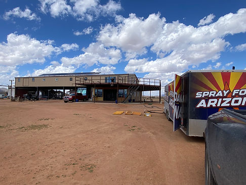 spray foam arizona rig in front of metal building