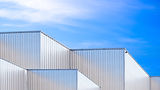 Factory industry, Architecture Building with Aluminium Facade on Blue Sky Background, Back