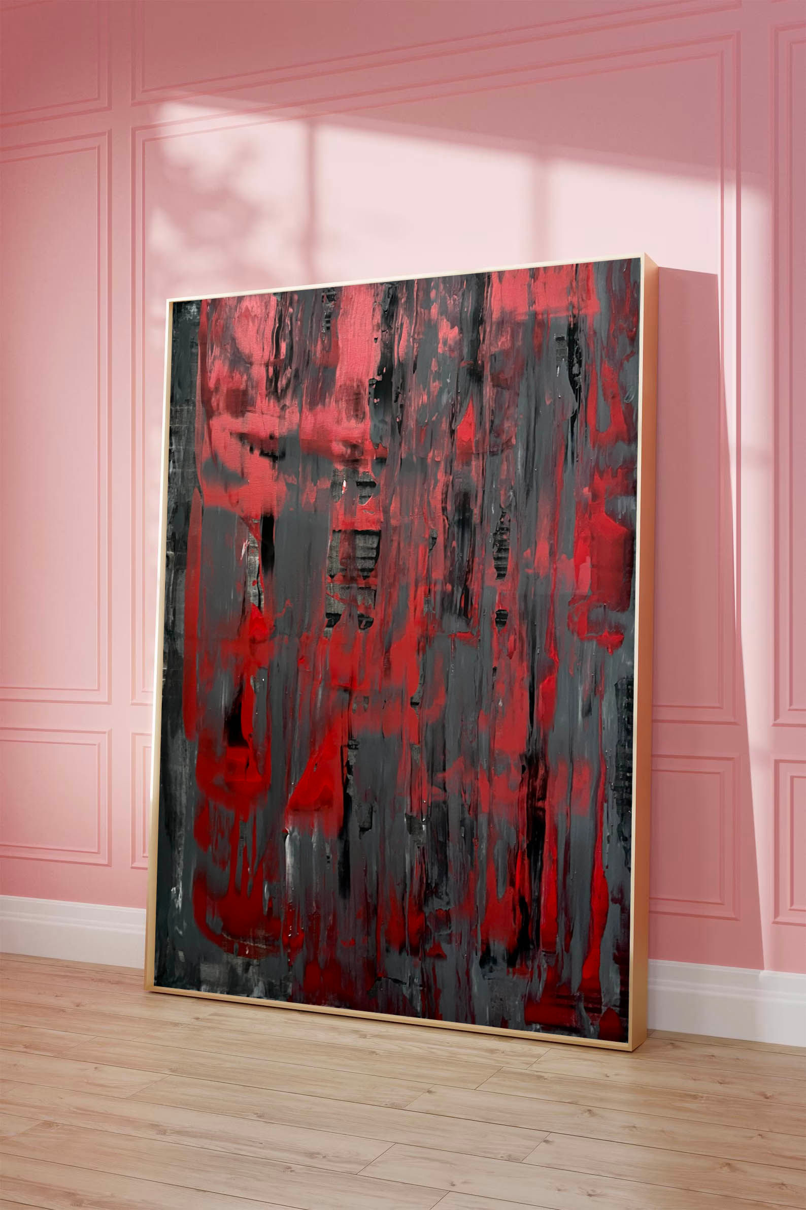 Abstract red and grey painting against a pink wall