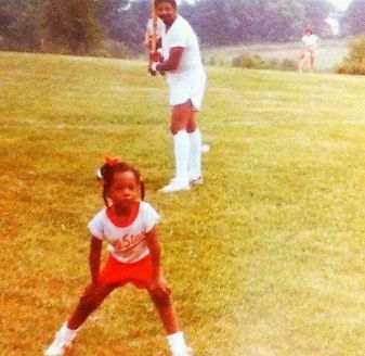 One of the adult daughters at three years old with her dad playing baseball