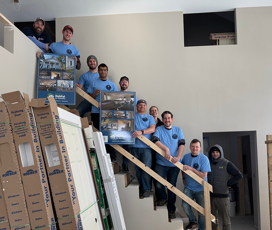 Team standing on stairs for local family advocacy.