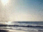 dark floaters seen against the bright sky at the beach