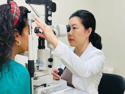 an eye doctor performing a laser treatment on a patient