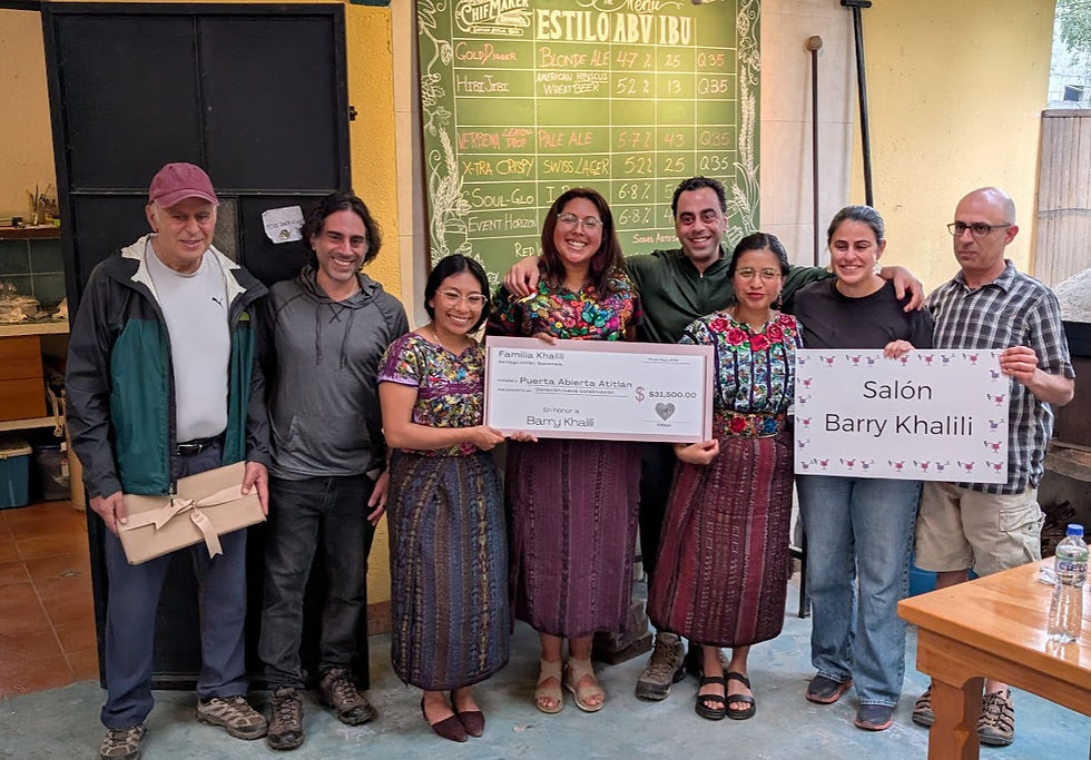 A group of volunteers for Building Goodness Foundation present a check in memory of Barry Khalili, a dedicated BGF supporter