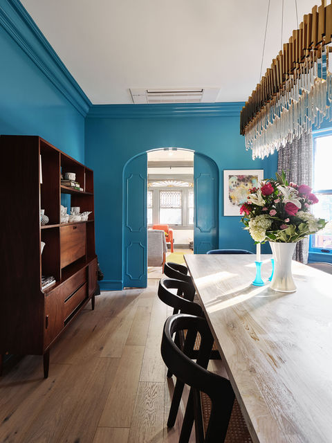 Bright dining room with contemporary furniture and original moldings in renovated Victorian house
maximalist