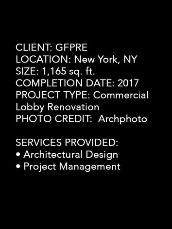 Black and wood reception desk with marble walls illuminated by Bocci lighting in New York office