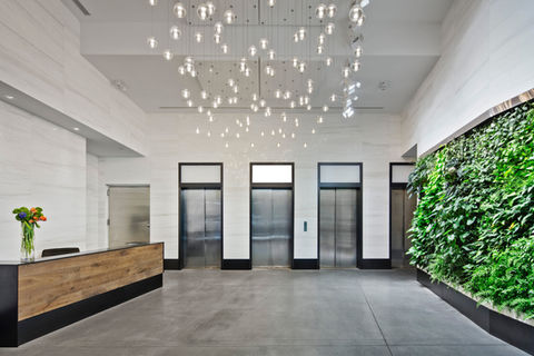green plants live wall lobby bocci chandelier lights