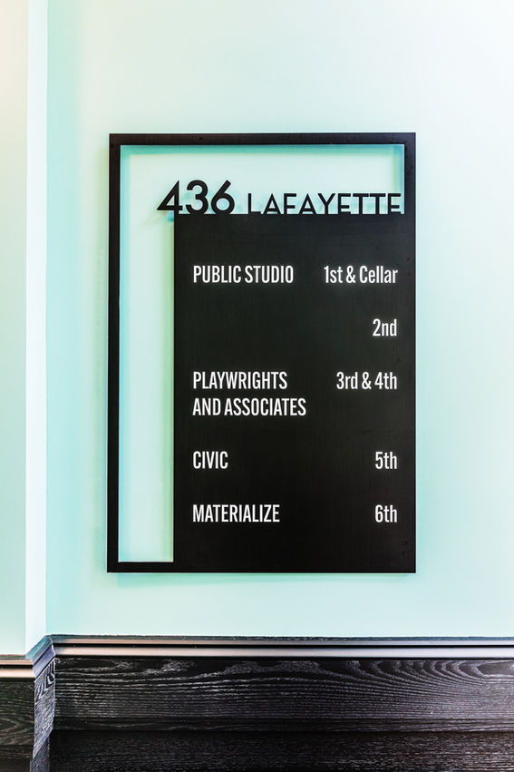 Custom steel-framed directory sign with modern typography in renovated Lafayette lobby