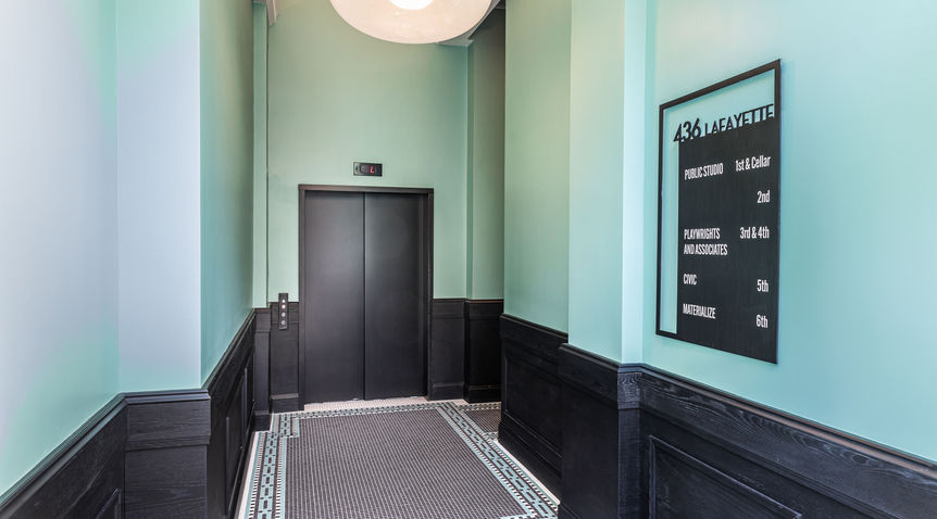 Custom steel-framed directory sign with modern typography in renovated Lafayette lobby