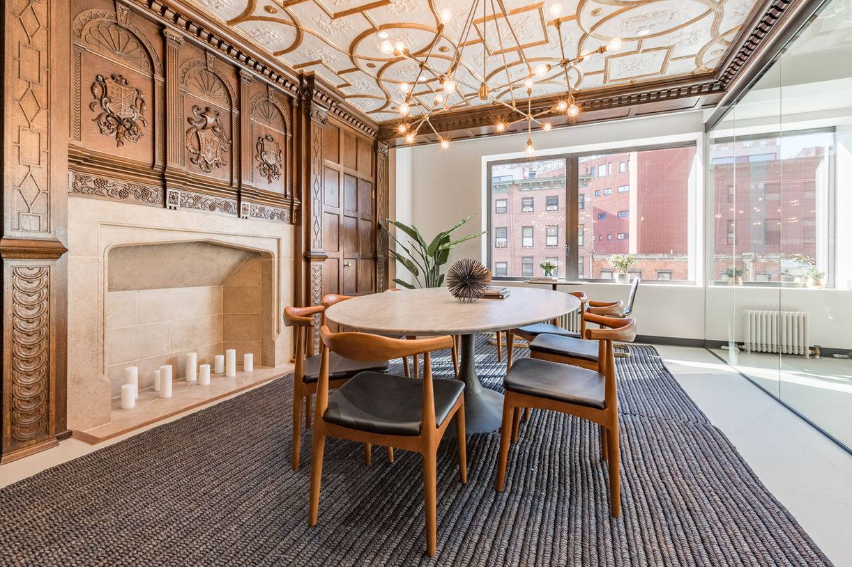 Conference room with restored carved fireplace and coffered ceiling at 80 Eighth Avenue office