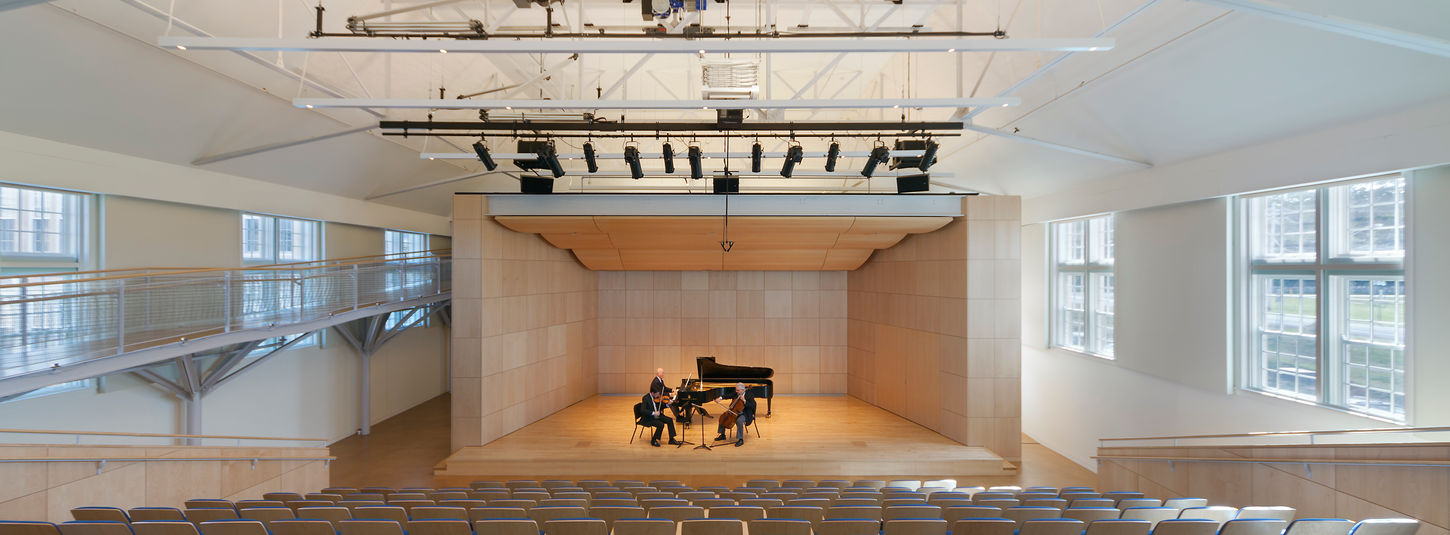 Tiered seating and acoustic stage shell within the 250-seat recital hall at SUNY Geneseo Doty Hall.
