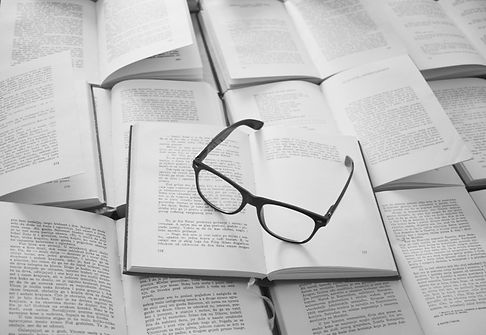 black framed eyeglasses on white book page_edited.jpg