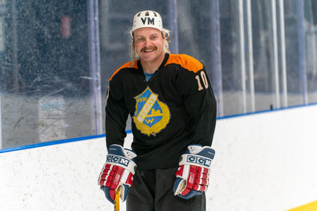 Valtteri Bottas in black Viipurin Reipas jersey smiling on the rink.