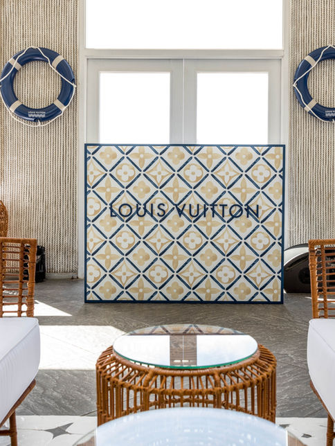 Louis Vuitton branded trunk and cushions at outdoor setup