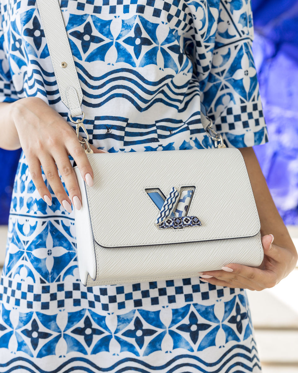 Close up of white Louis Vuitton handbag with silver logo
