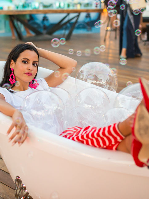 Woman in bathtub with bubbles at party