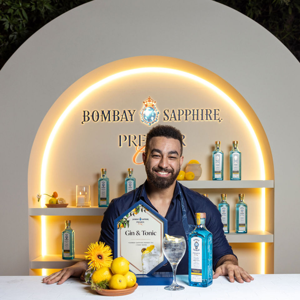 Symmetrical Bombay Sapphire branded bar with bartender
