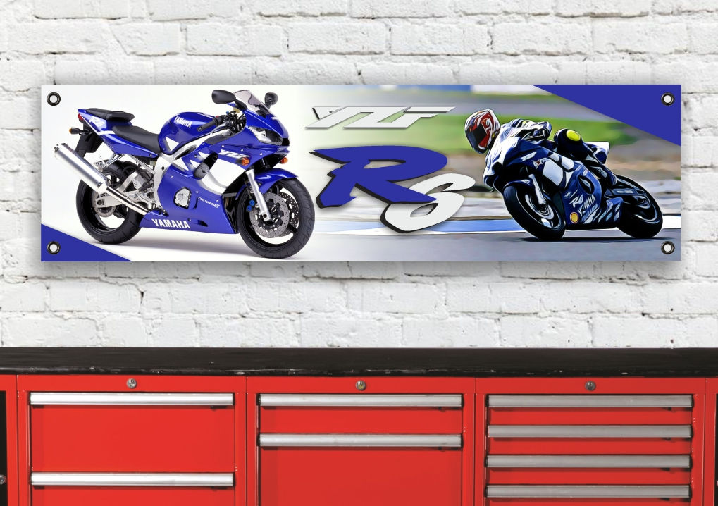 Blue YZF R6 2000 banner with motorcycles and text on a brick wall background.