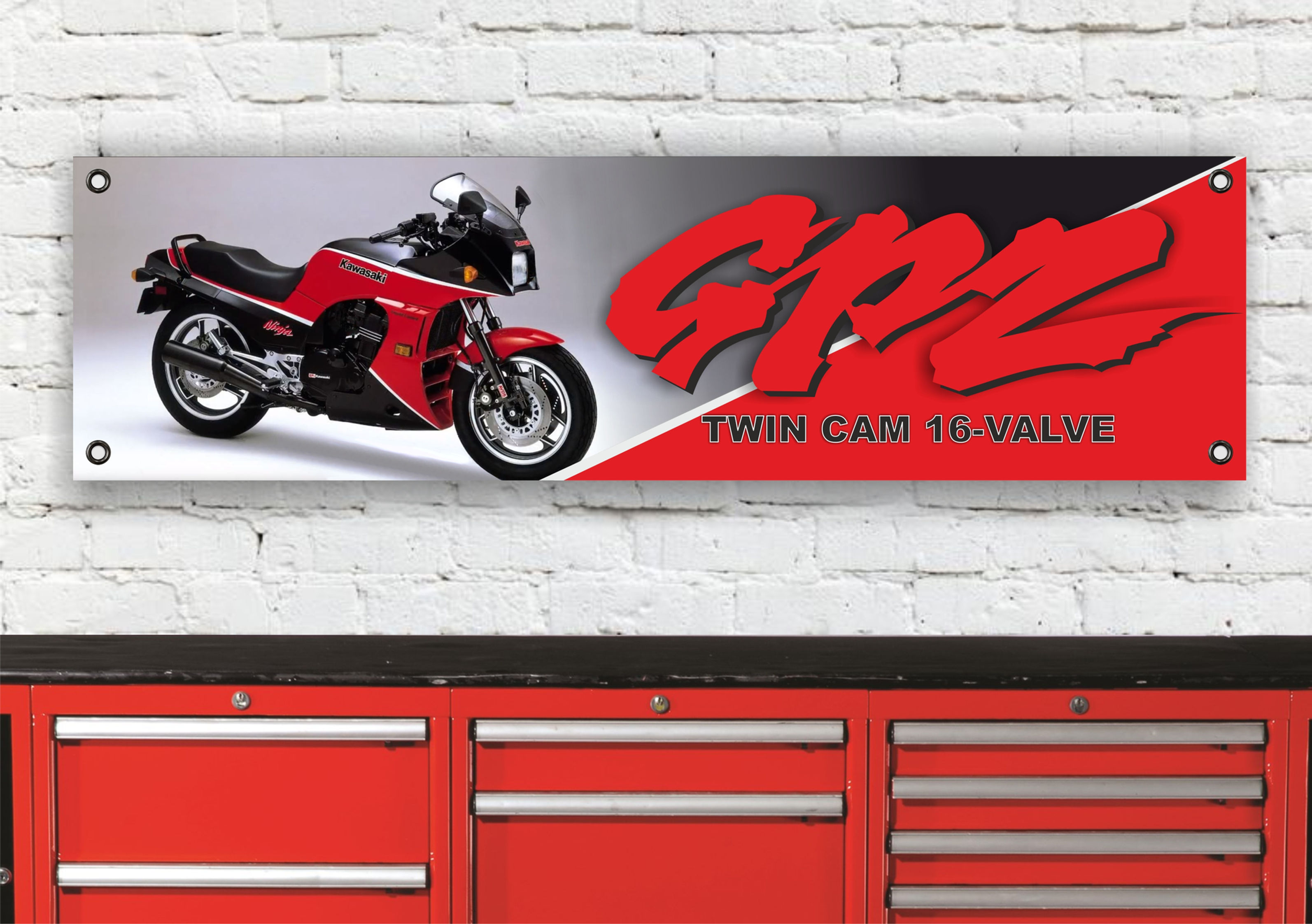 Red GPZ900R motorcycle banner against a brick wall, Twin Cam 16 Valve GPZ900R TOP GUN.