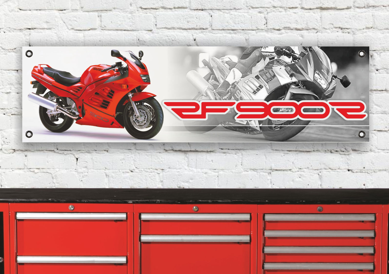 Red motorcycle with the text RF900 on a white brick wall background