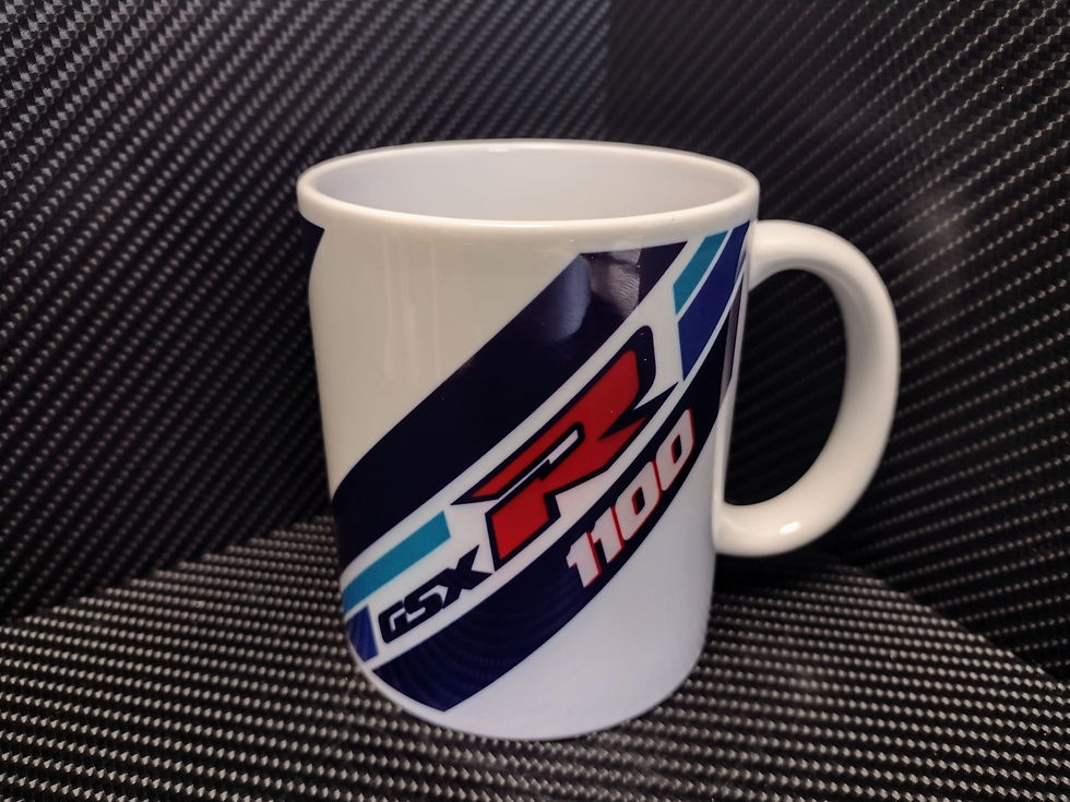 White Suzuki GSX-R 1100 mug sits on a surface, with blue stripes.