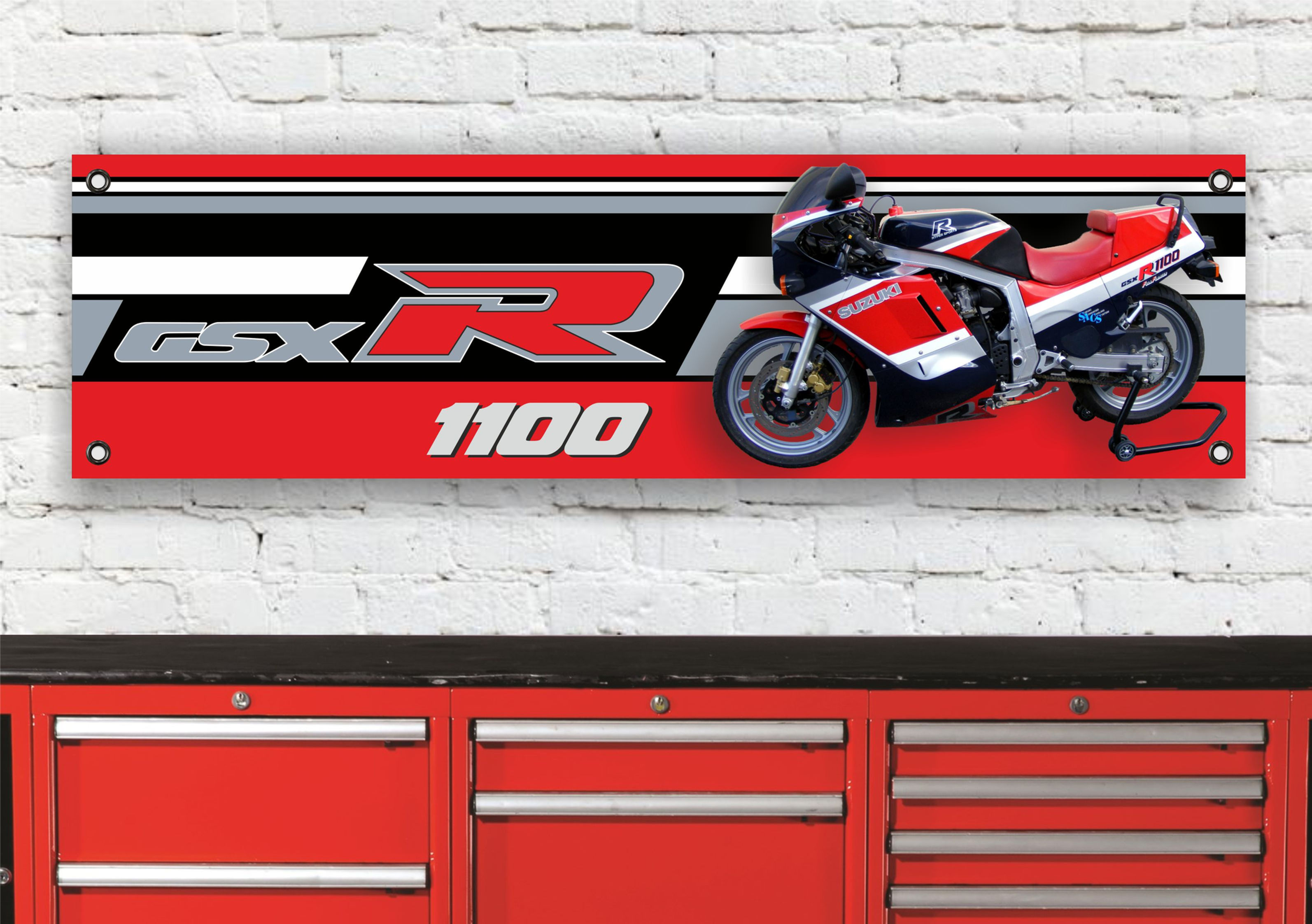 Red and white GSX R 1100 motorcycle with matching colors against a wall