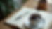 High angle view of a desk with a cup of coffee and a notebook during a break