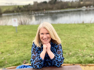 Lynda Fitzpatrick. Photo of woman sitting next to a lake.