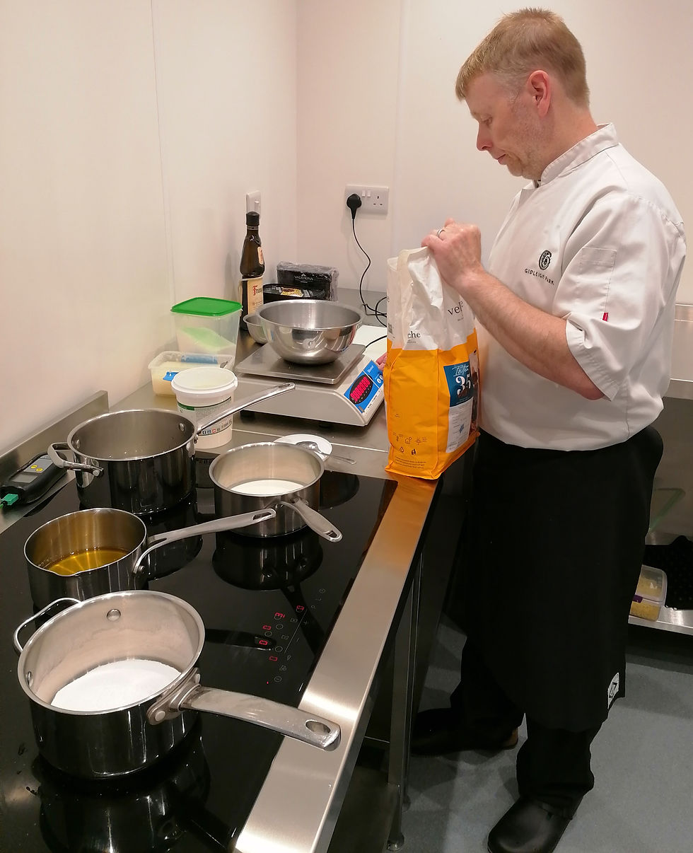 Eye-level view of an artisan chocolate maker preparing a new batch of truffles