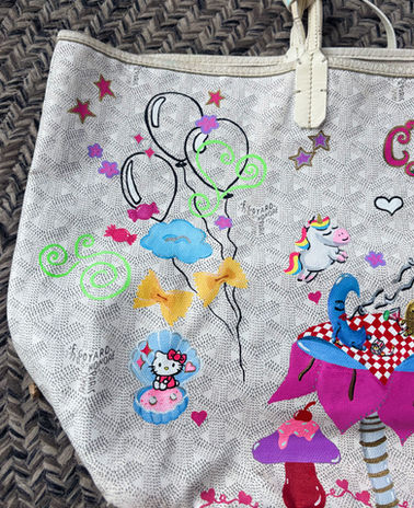 Hand-painted Goyard bag featuring original whimsical illustrations, fairy-inspired artwork, colorful fantasy details, and personalized elements unique to the owner. Custom luxury designer bag transformed into wearable art with playful hand-drawn characters and dreamy aesthetics.
