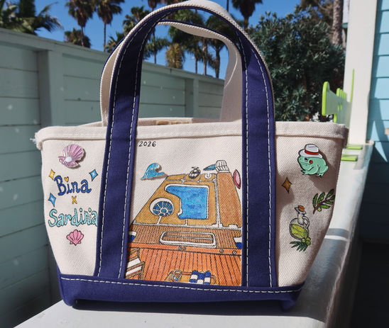 A hand-drawn canvas boat tote featuring colorful, whimsical illustrations inspired by life on the water. Designed to carry boating essentials, the tote combines playful artwork with everyday functionality, making it perfect for lake days, beach trips, and boating adventures.