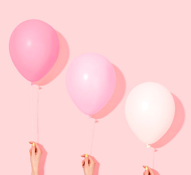 Hands Holding Balloons
