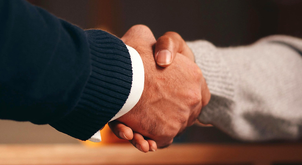 white man and black woman shaking hands closup of hands