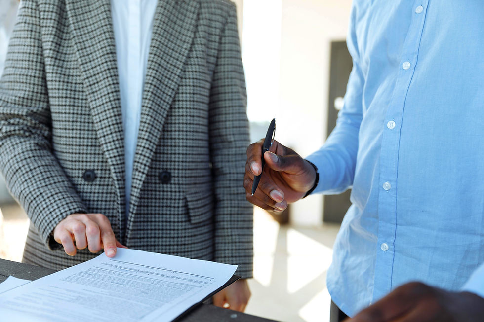 two people at chest/stomach level signing document