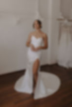 Model wearing the Sierra strapless silk satin wedding dress with high slit and draped bodice, handcrafted by Sally Victoria C