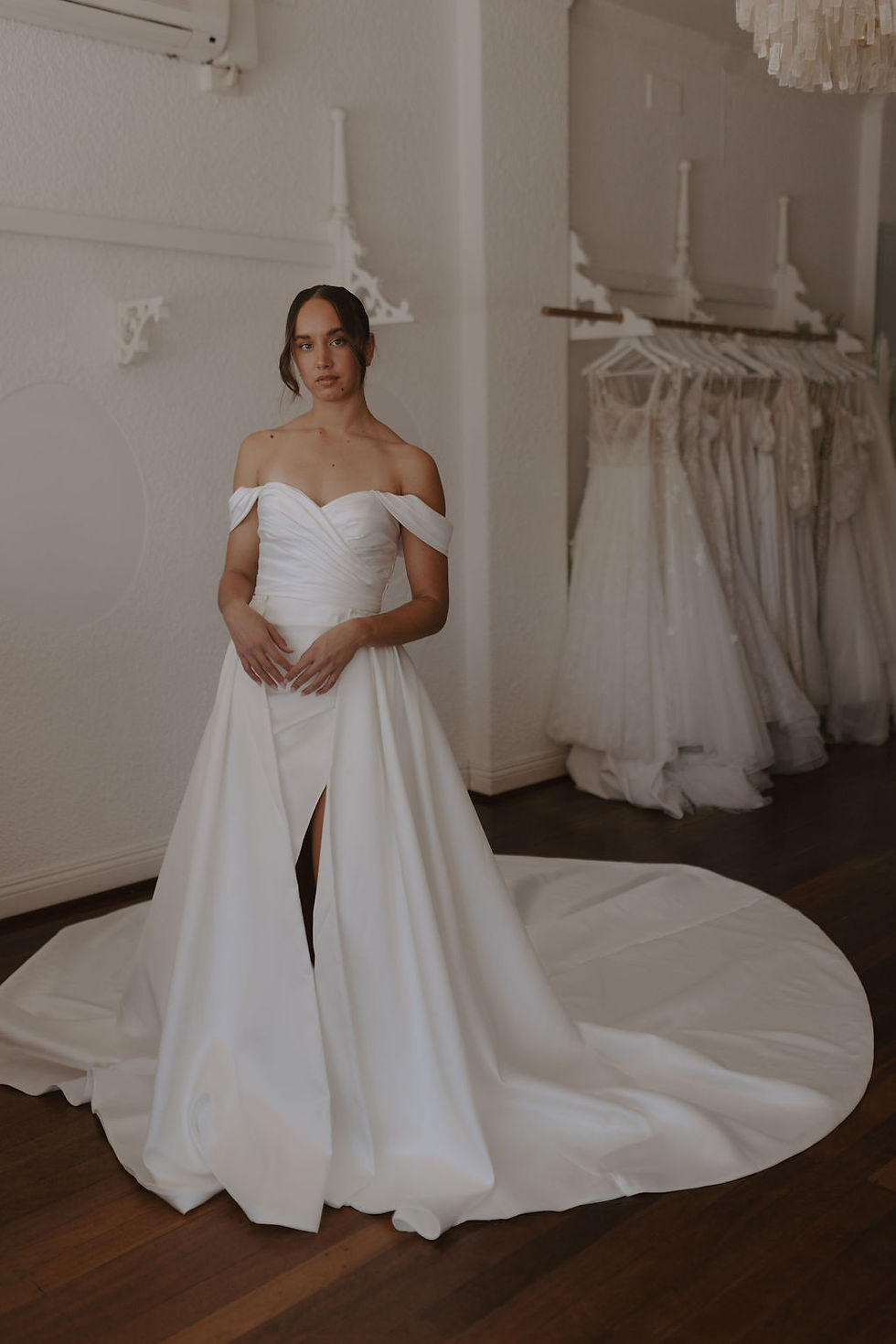 Thumbnail: Front view of the Sierra gown with draped bodice, high slit, detachable sleeves, and full overskirt by Sally Victoria Couture