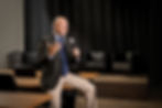 Stephen Kotev speaking at a leadership and conflict resolution event, seated in a seminar room