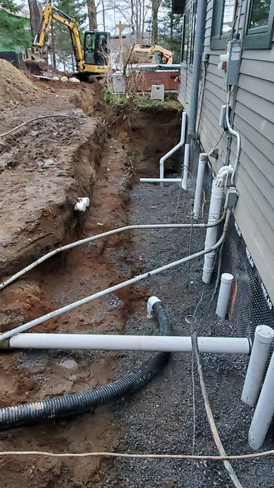 Electrical utility work extending from a house into recently excavated grounds