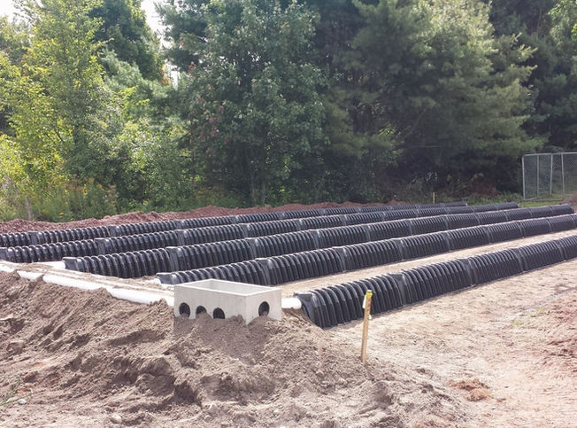 A leach field septic system in the dirt ground