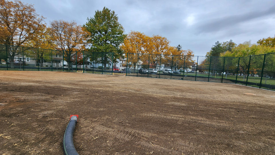 A large dirt field covered in topsoil