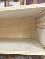 A three-sided box with interior grooves.